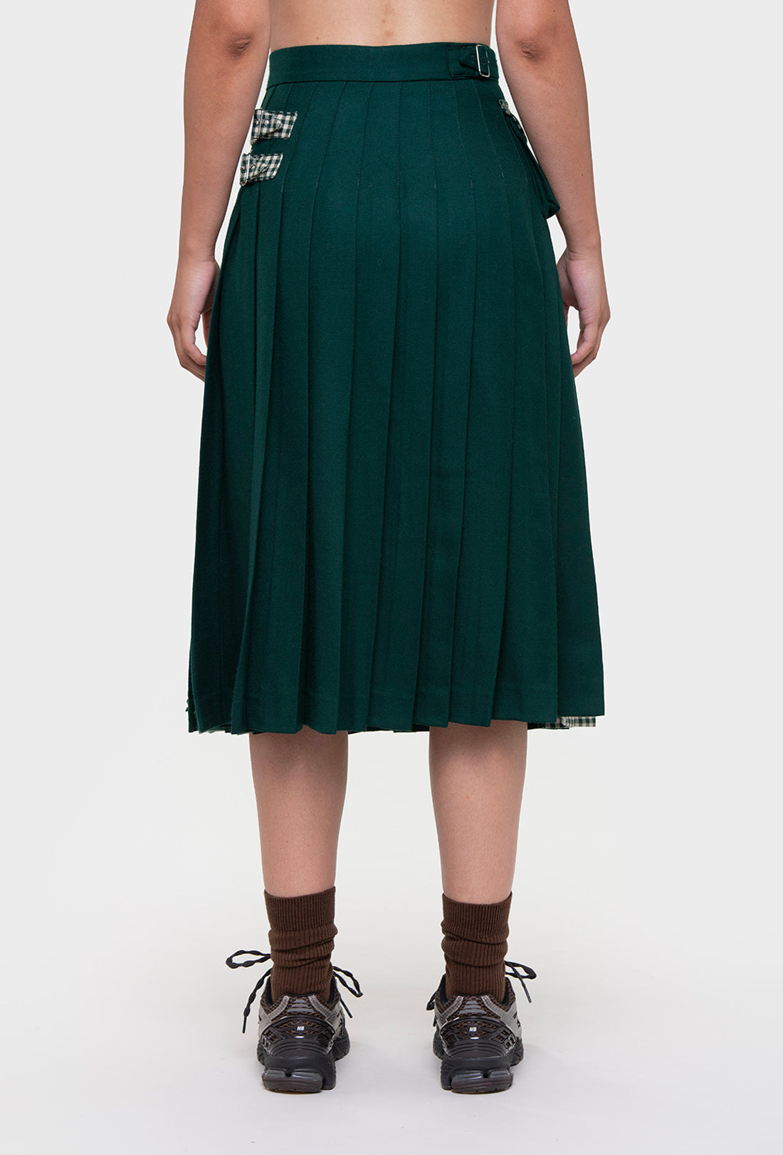 Shrimps Anya wool Kilt. Green gingham kilt with contrasting plain green on the back. Buckle fastenings with side pocket. Woven and made in Scotland. AW26