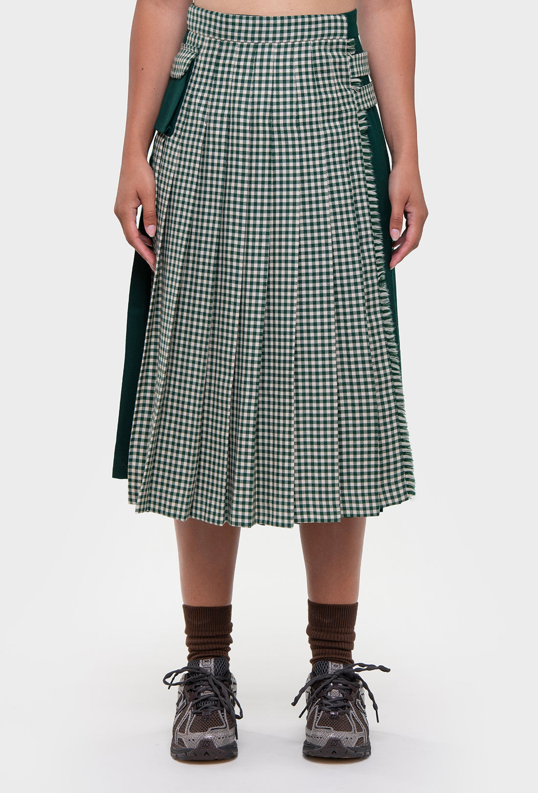 Shrimps Anya wool Kilt. Green gingham kilt with contrasting plain green on the back. Buckle fastenings with side pocket. Woven and made in Scotland. AW26