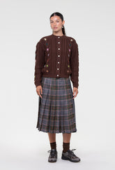 Shrimps Anya wool Kilt. Grey Stewart tartan kilt with contrasting plain grey on the back. Buckle fastenings with side pocket. Woven and made in Scotland. Worn with the Erwin cardigan. AW26