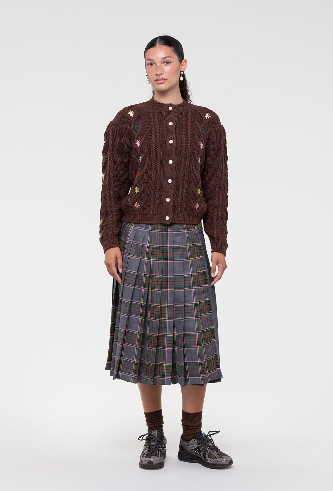 Shrimps Anya wool Kilt. Grey Stewart tartan kilt with contrasting plain grey on the back. Buckle fastenings with side pocket. Woven and made in Scotland. Worn with the Erwin cardigan. AW26